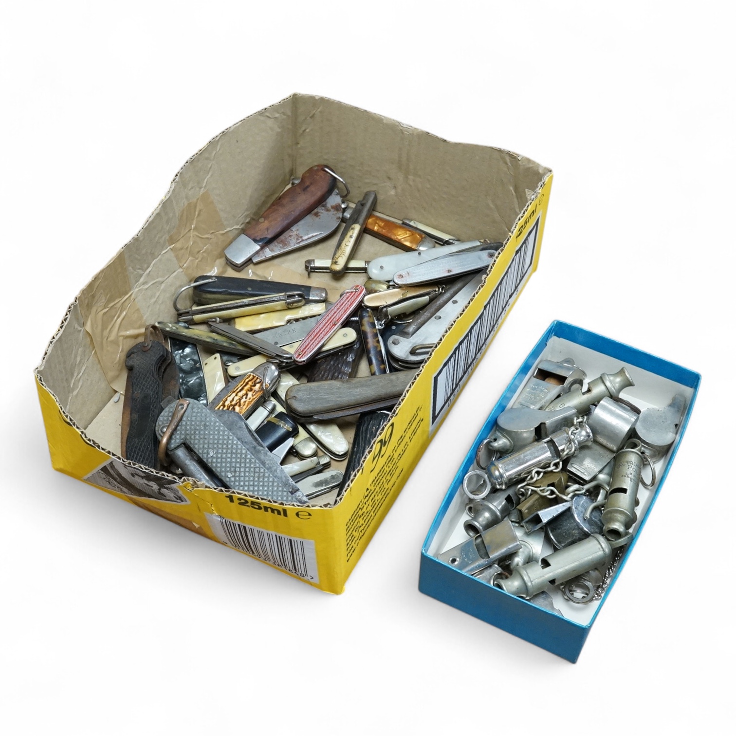 A collection of assorted penknives and whistles